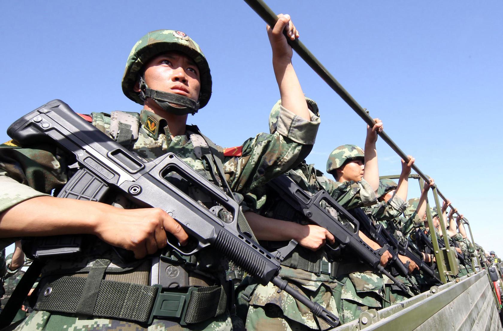 An anti-terrorism force including public security police and the armed police attend an anti-terrorism joint exercise in Hami, northwest China's Xinjiang region on July 2, 2013. The United States is encouraging "terrorism" in Xinjiang, Chinese state media said on July 1, also claiming that separatists in the region -- which has a large Uighur minority -- had fought alongside Syrian rebels. CHINA OUT AFP PHOTO (Photo credit should read STR/AFP/Getty Images)