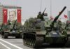 Turkish army tanks roll past a portrait of Mustafa Kemal Ataturk during a military parade in Ankara