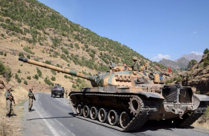 Turkish soldiers in a tank and an armored vehicle patrol on the road to the town of Beytussebab in the southeastern Sirnak province, Turkey Turkish soldiers in a tank and an armored vehicle patrol on the road to the town of Beytussebab in the southeastern Sirnak province, Turkey